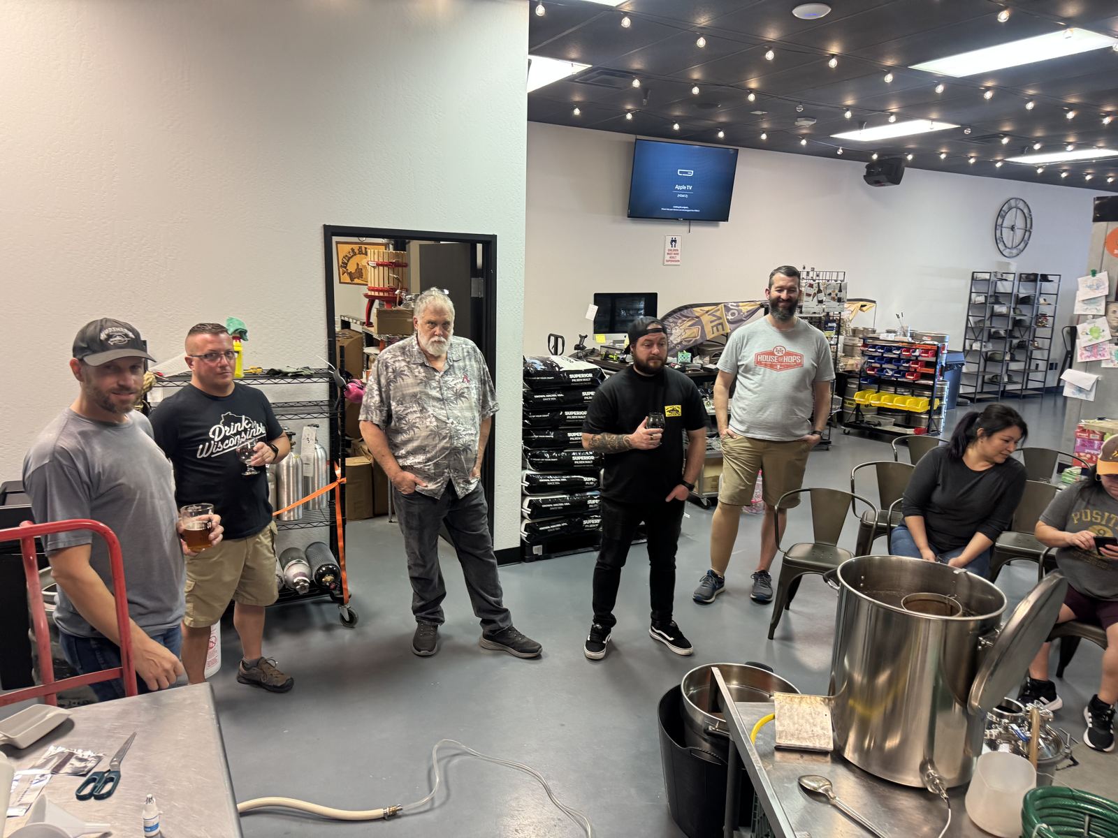 A brewing class gathered around the kettle