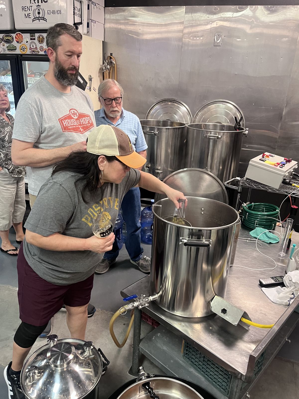 A student stirring the mash while the instructor watches
